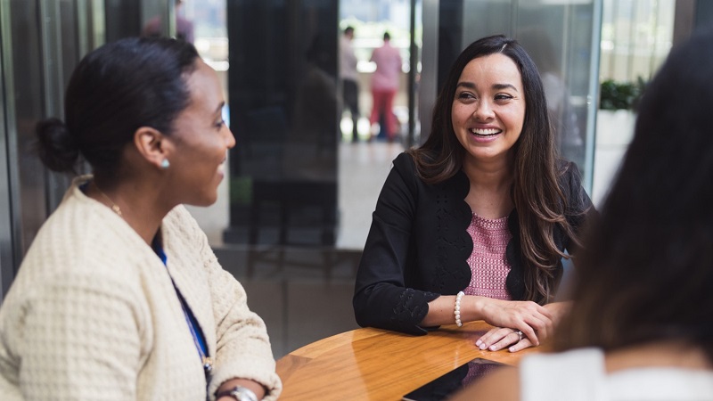 Two people smiling talking